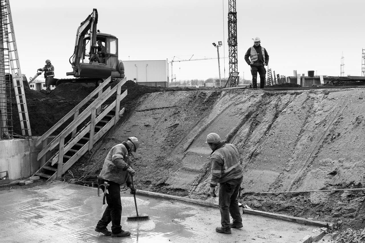 Die Fertigstellung einer Bodenplatte. Einer der Polierer kontrolliert den Fortschritt. -  Dinslaken. Deutschland. Februar 2016